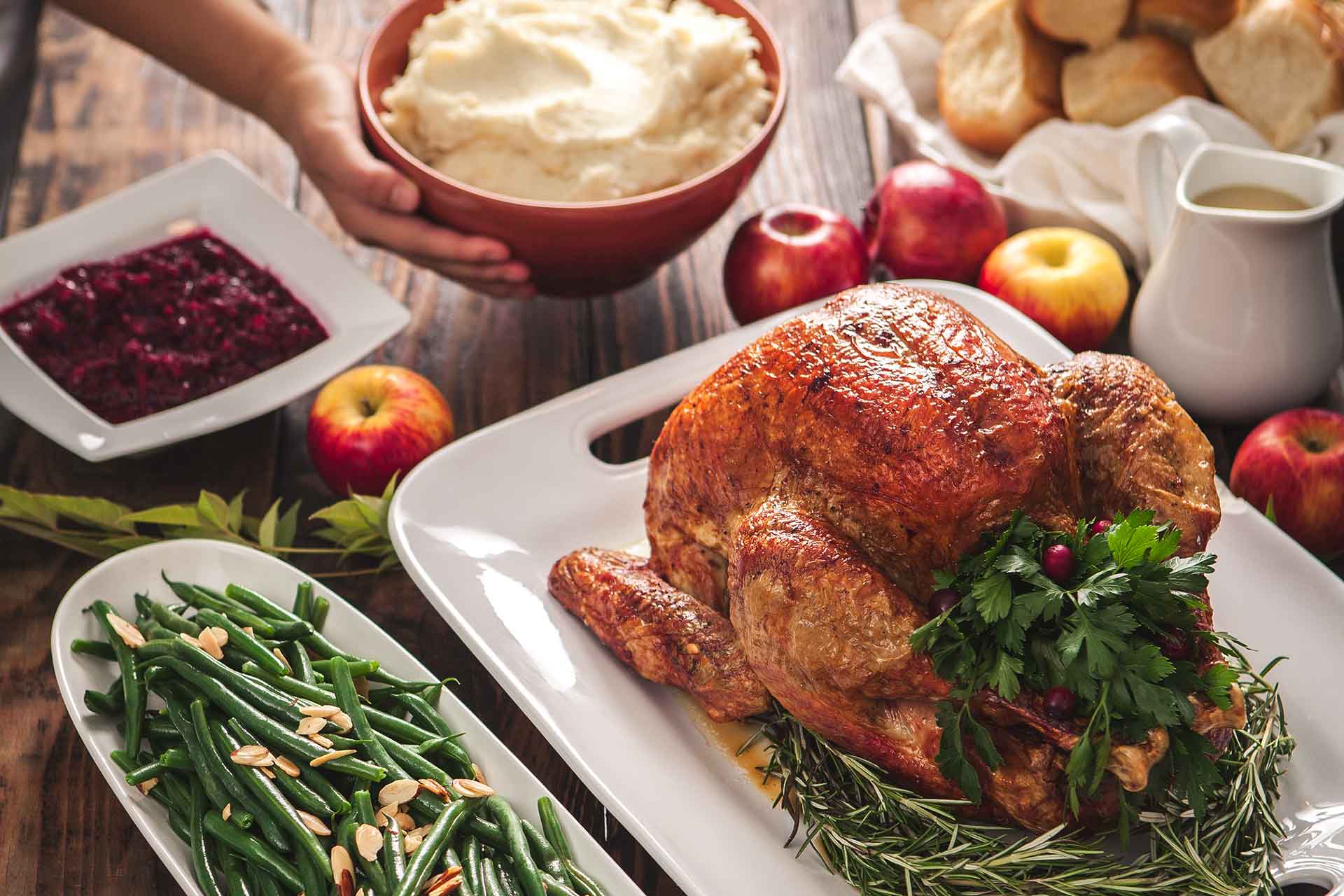 Woman serving roasted turkey