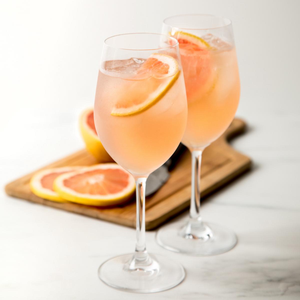 sparkling rose cocktail with grapefruit in the background