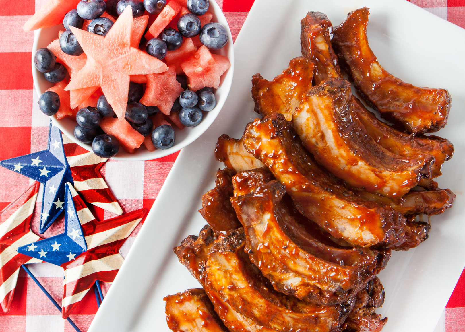 plate of ribs and bowl of fruit